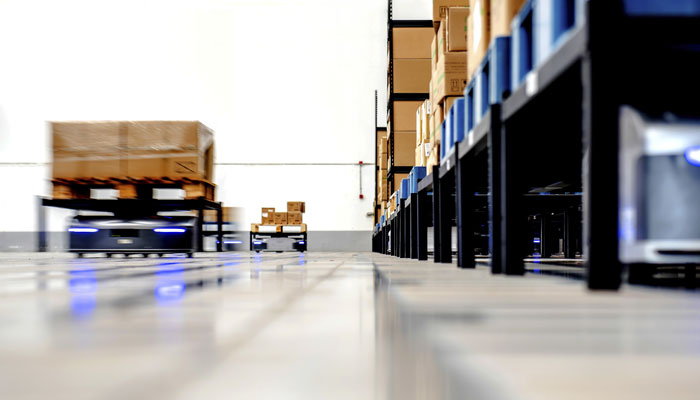 Robots moving product in a sophisticated logistics warehouse